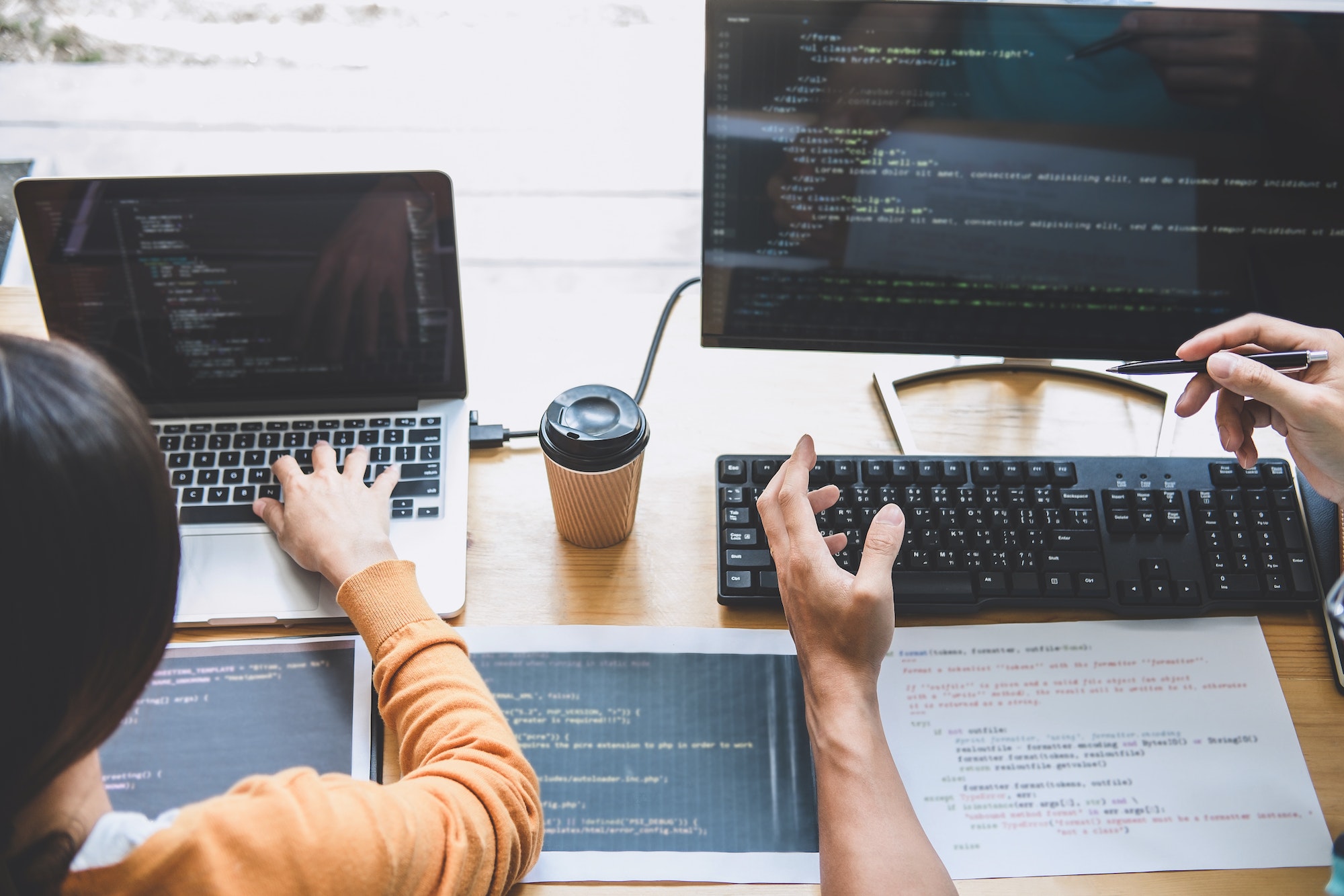 Two professional programmer cooperating and working on web site project in a software developing on